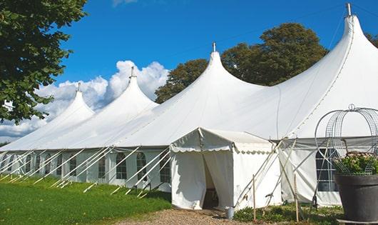 tall green portable restrooms assembled at a music festival, contributing to an organized and sanitary environment for guests in Carmel By The Sea